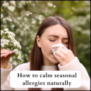 Woman blowing her nose during spring allergy season with blossom in the background